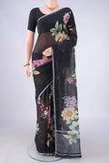 Black Linen Saree with Floral Print on the body and Zari Border.  displayed on a mannequin