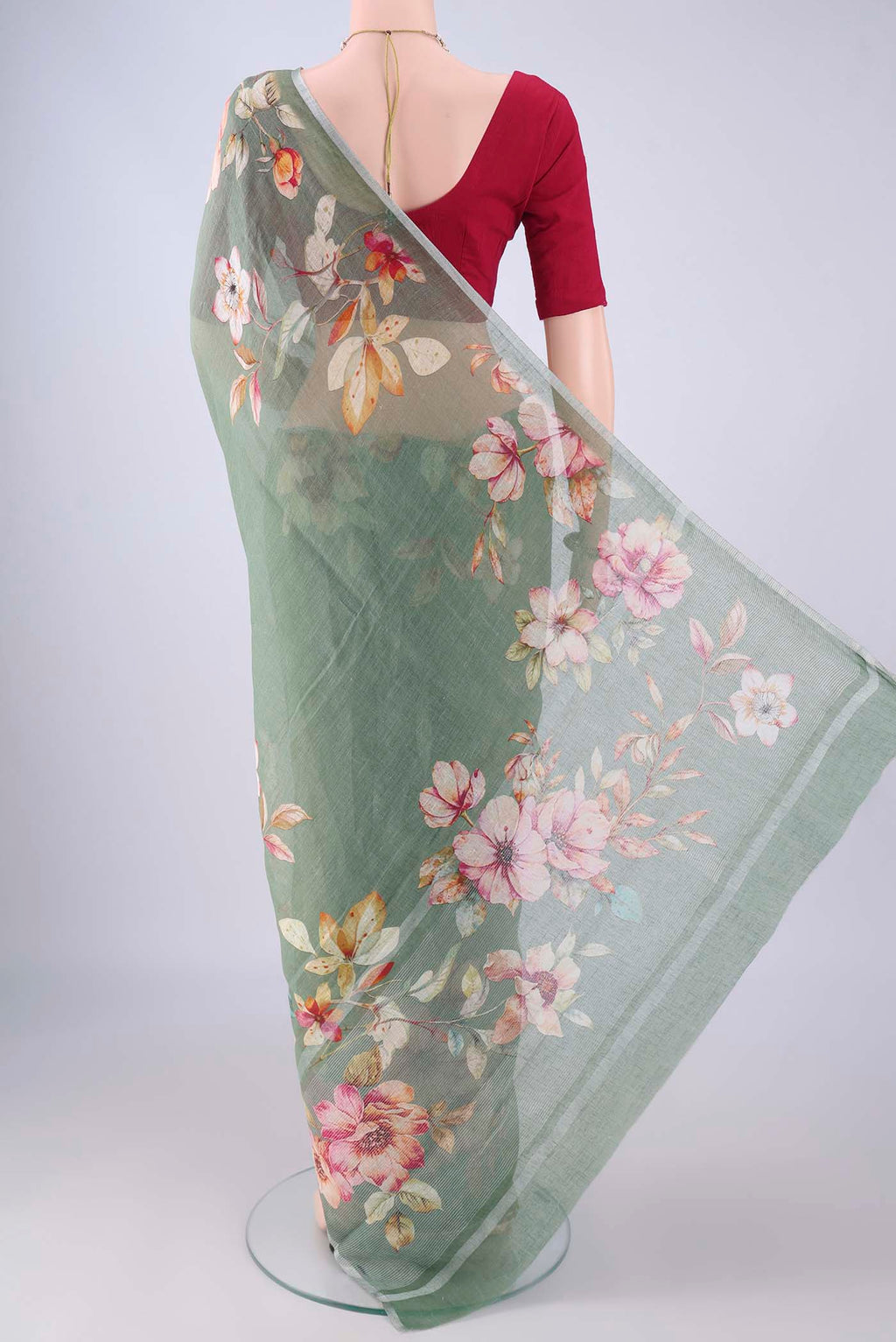 Flat view of Sage Green Linen Saree with Floral Print on the body and Zari Border. 