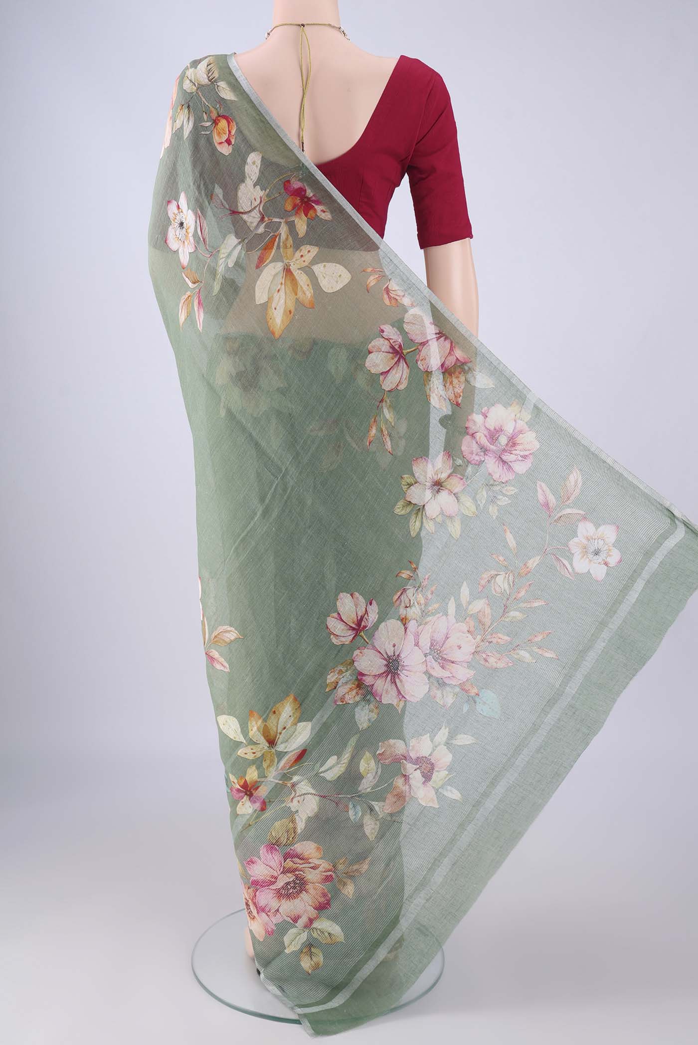 Flat view of Sage Green Linen Saree with Floral Print on the body and Zari Border. 