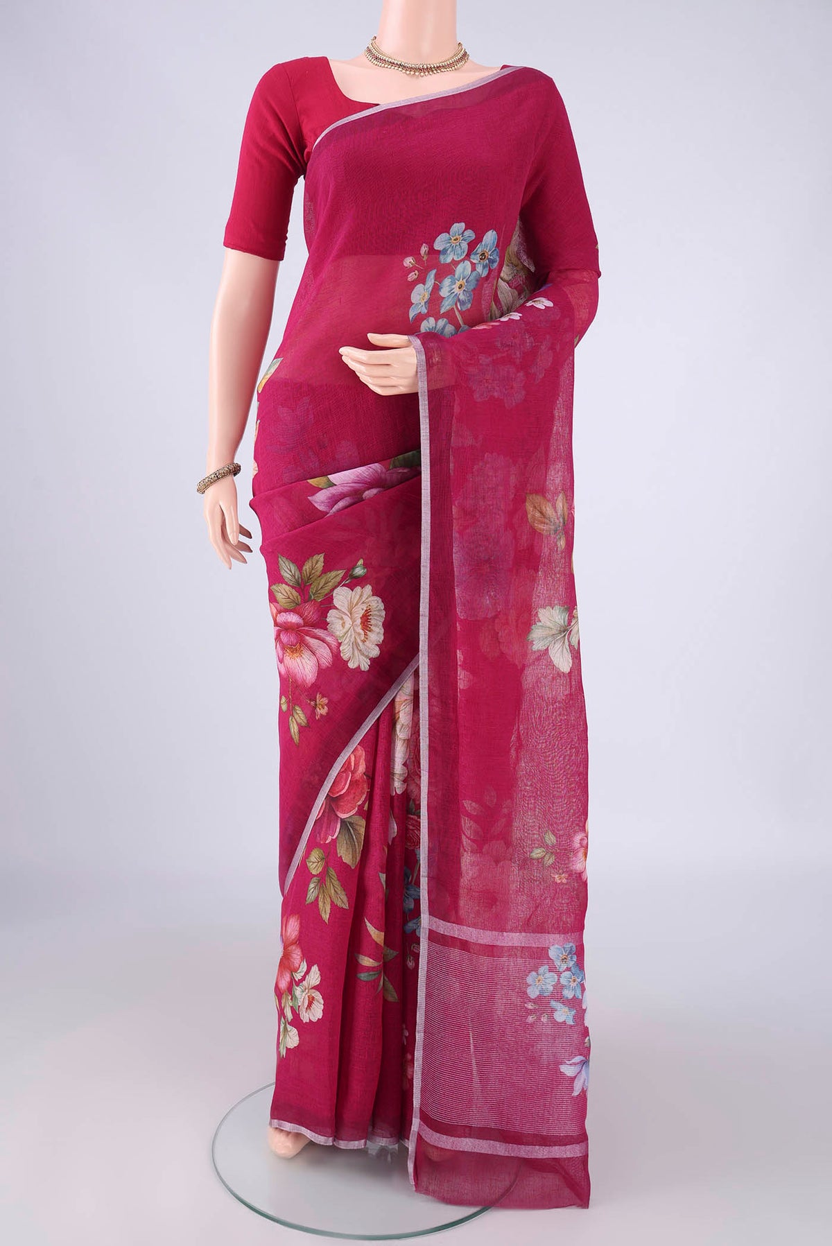 Dark Pink Linen Saree with Floral Print on the body and Zari Border.  displayed on a mannequin