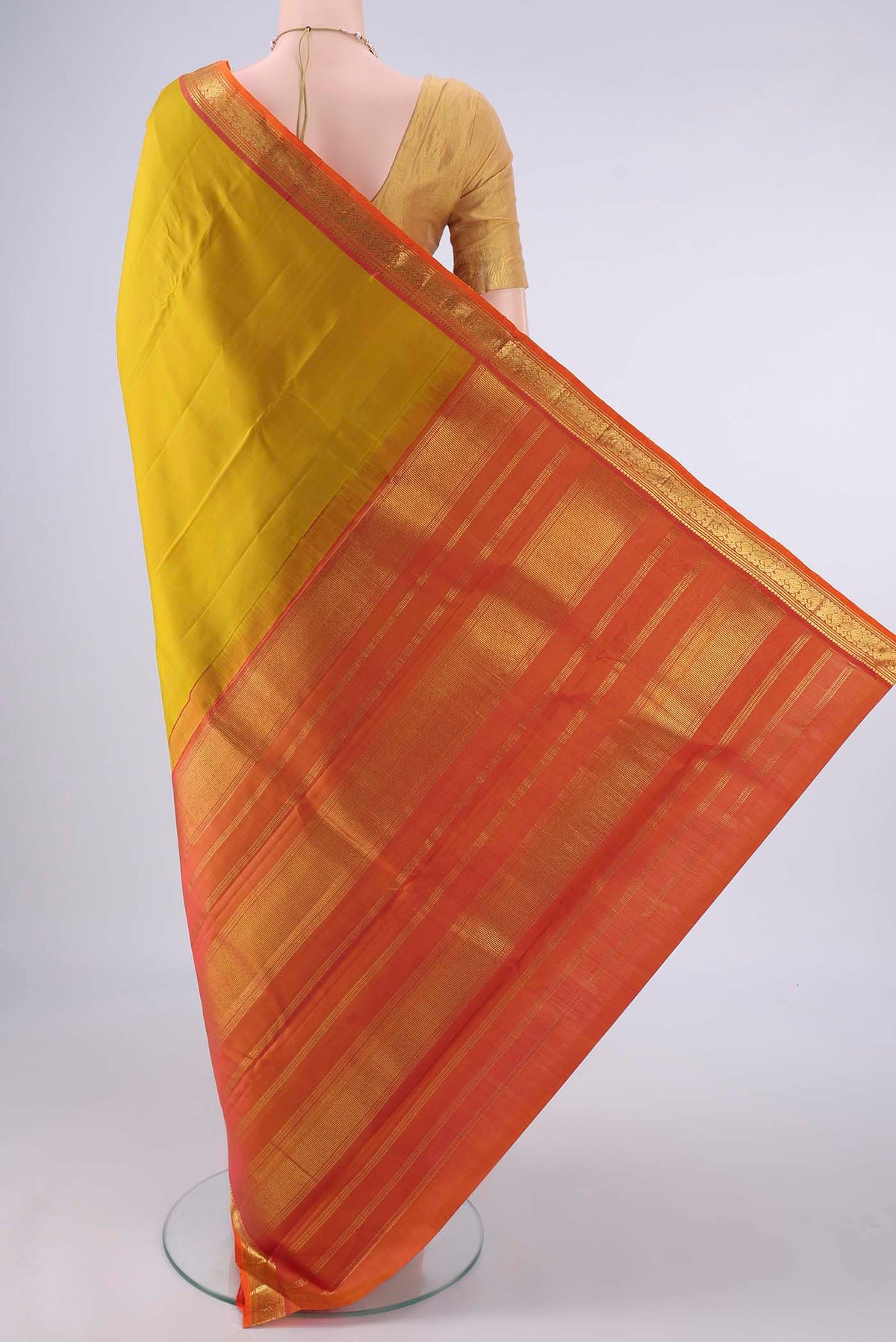 Flat view of Pure Silk Mustard Kanjivaram Saree with Plain Body and Zari Border. 