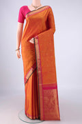 Brick Orange Kanjivaram Silk Saree with Zari Butta on the body and Zari Border.  displayed on a mannequin
