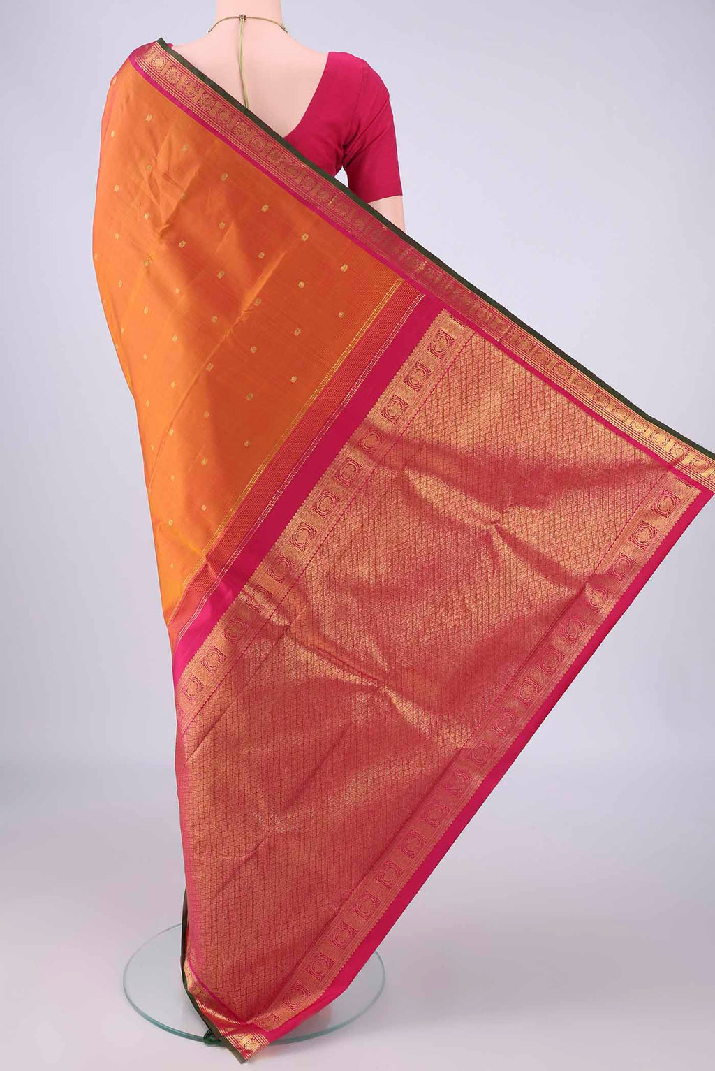 Flat view of Brick Orange Kanjivaram Silk Saree with Zari Butta on the body and Zari Border. 