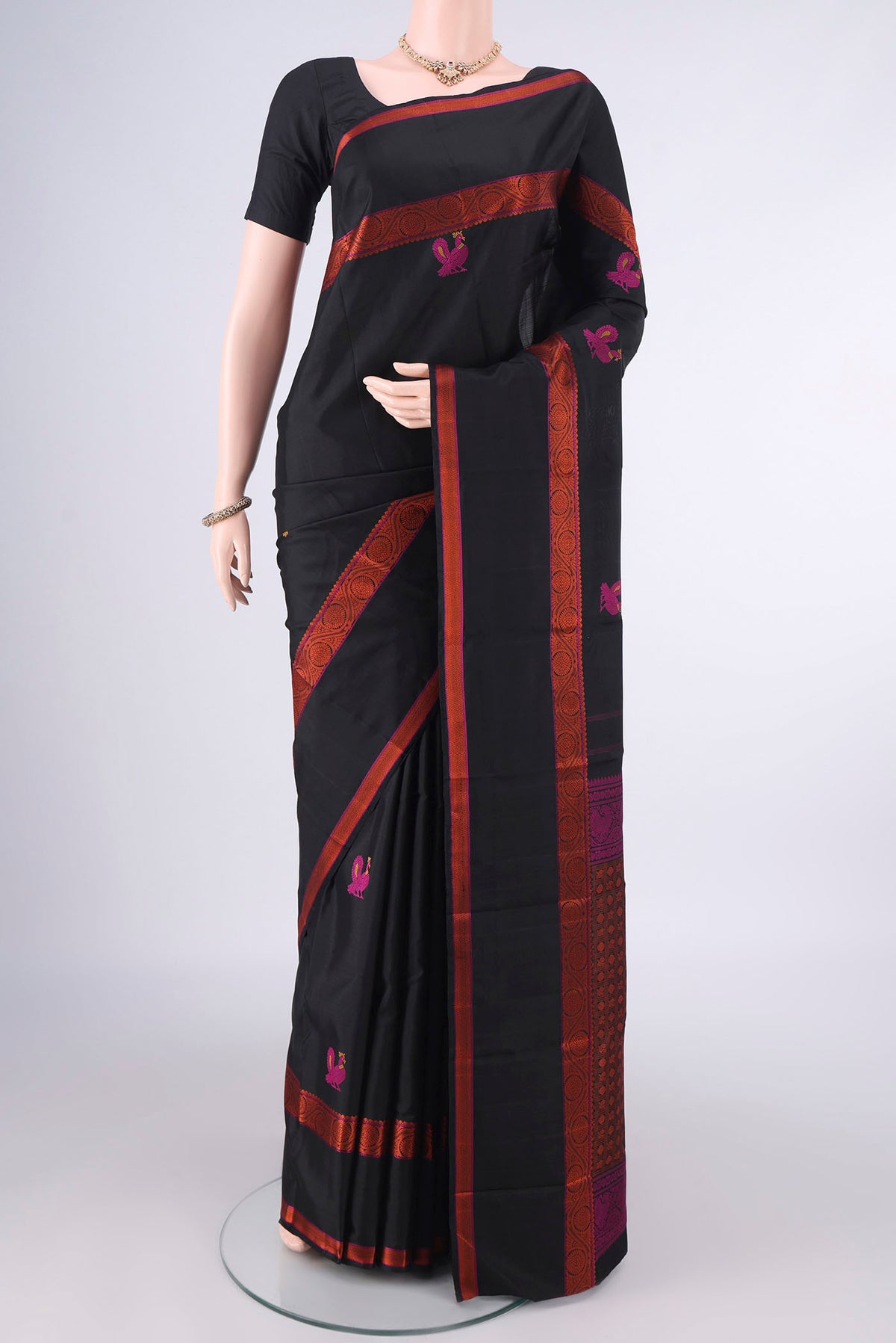 Pure Silk Black Kanjivaram Saree with Thread Butta on the body and Thread Border.  displayed on a mannequin