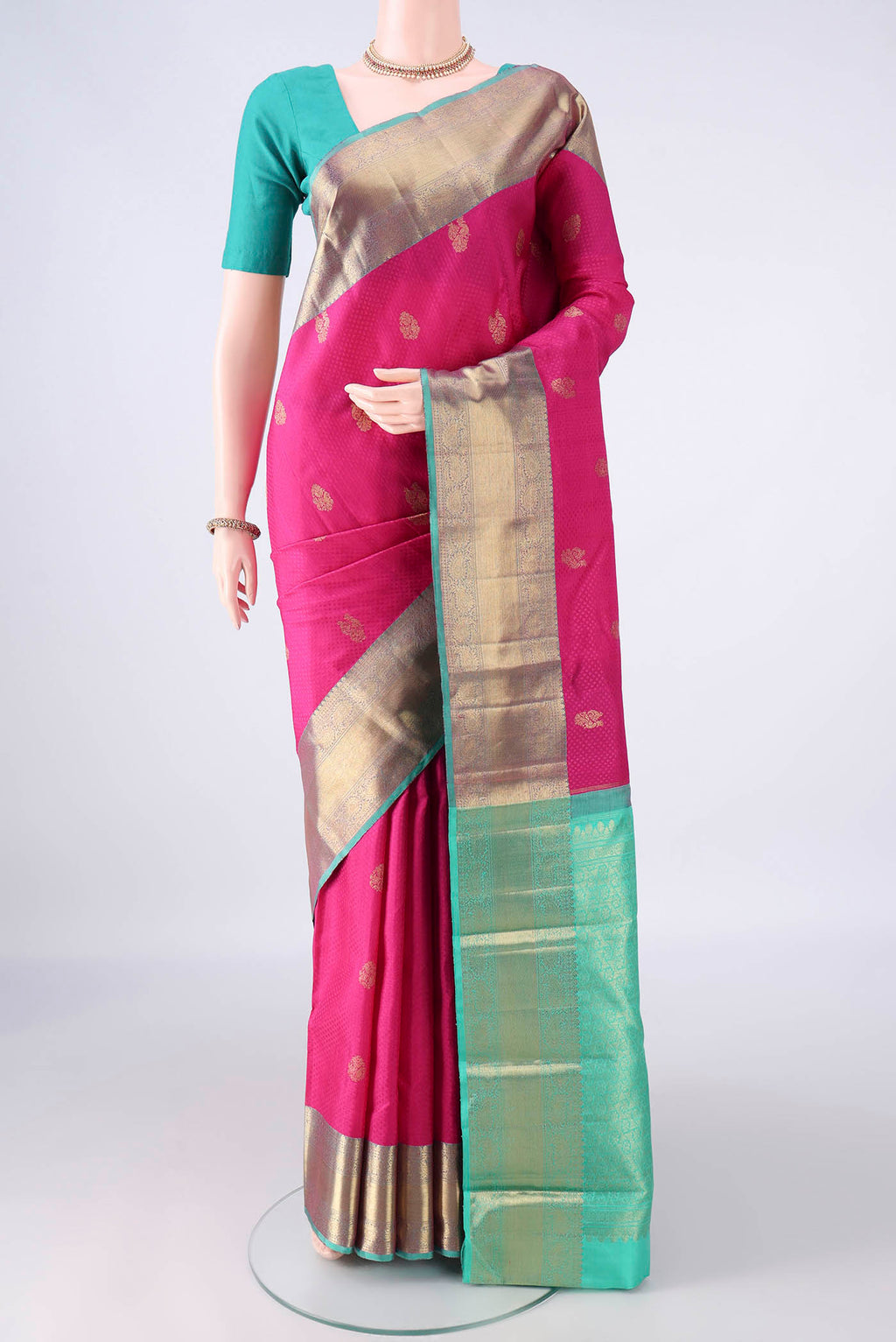 Pure Silk Rani Pink Kanchipuram Saree with Jacquard With Zari Butta on the body and Zari Border.  displayed on a mannequin