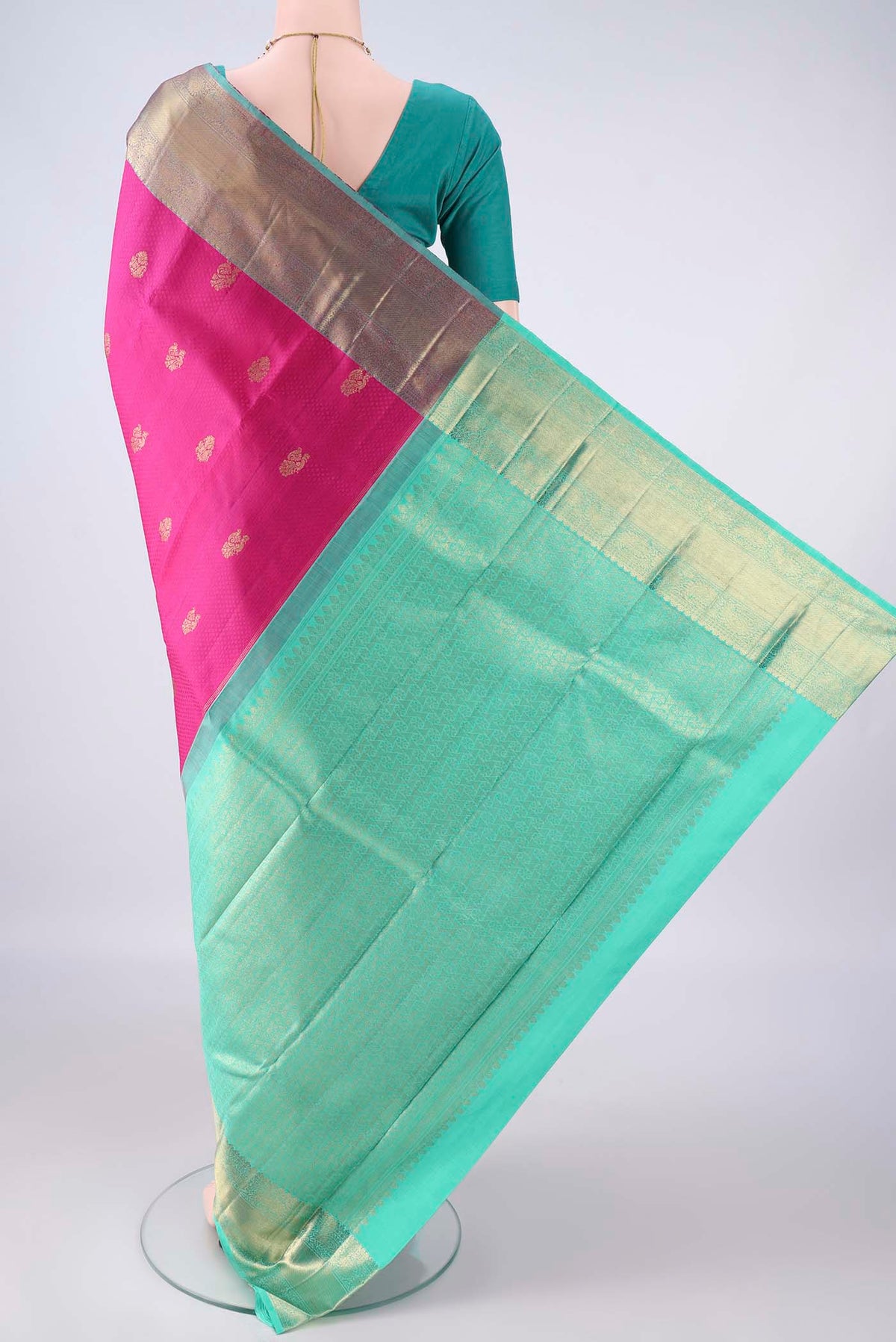 Flat view of Pure Silk Rani Pink Kanchipuram Saree with Jacquard With Zari Butta on the body and Zari Border. 