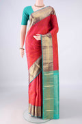 Pure Silk Brick Orange Kanchipuram Saree with Jacquard design on the body and Zari Border.  displayed on a mannequin