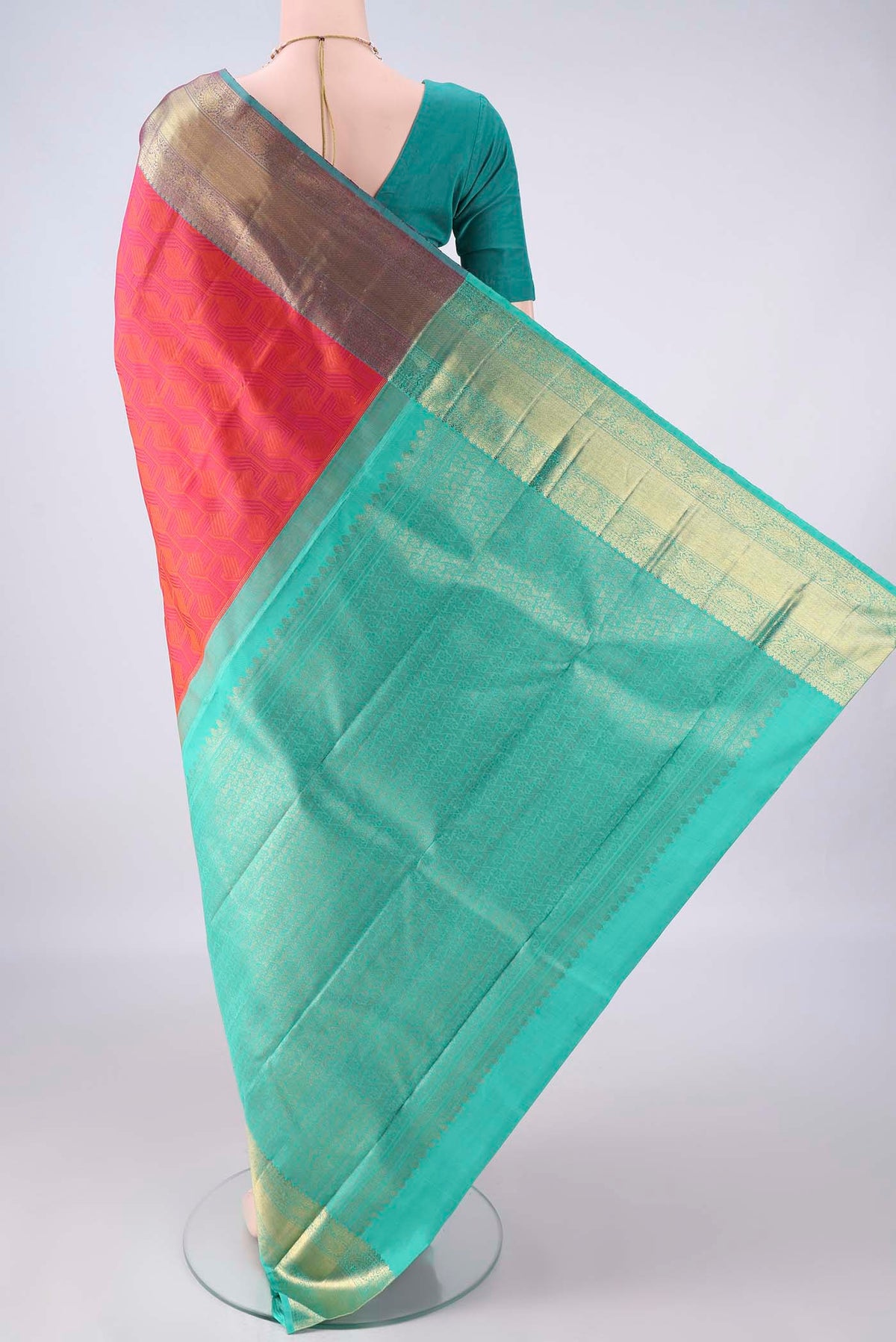 Flat view of Pure Silk Brick Orange Kanchipuram Saree with Jacquard design on the body and Zari Border. 