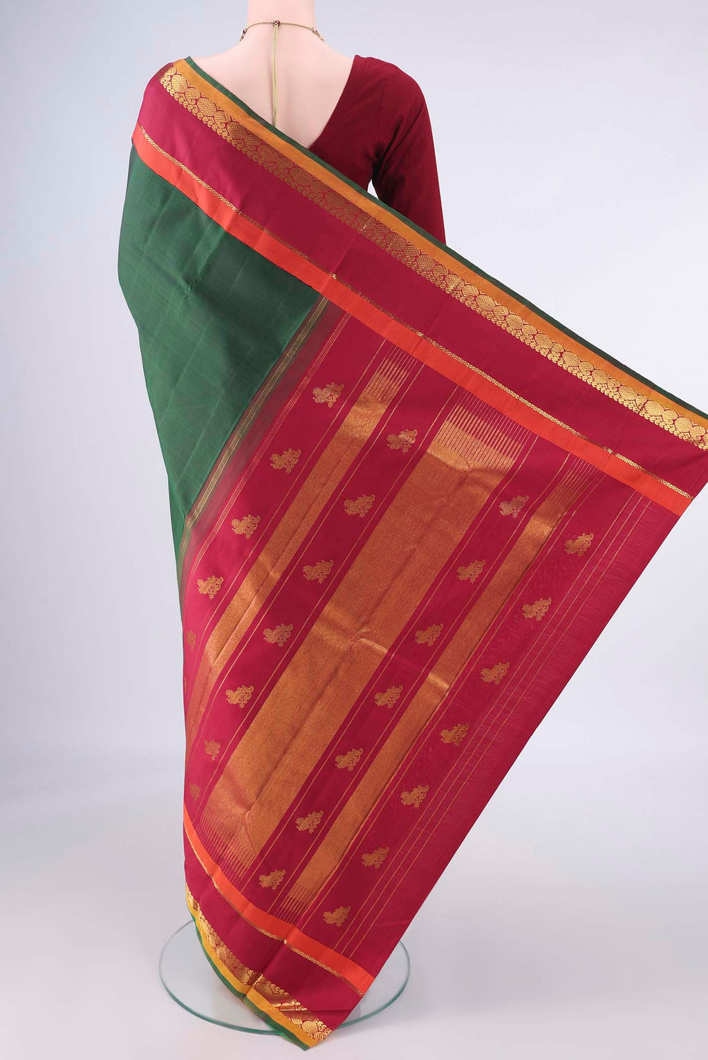 Flat view of Pure Silk Bottle Green Kanjivaram Saree with Plain Body and Zari Border. 