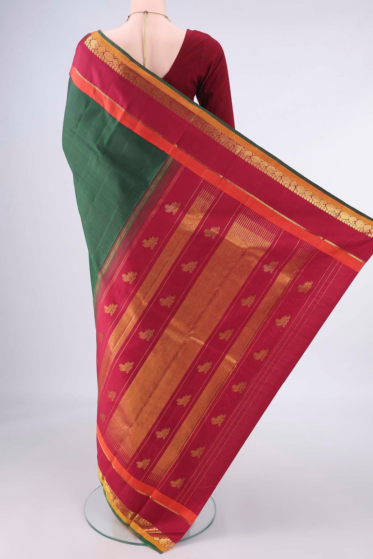 Flat view of Pure Silk Bottle Green Kanjivaram Saree with Plain Body and Zari Border. 