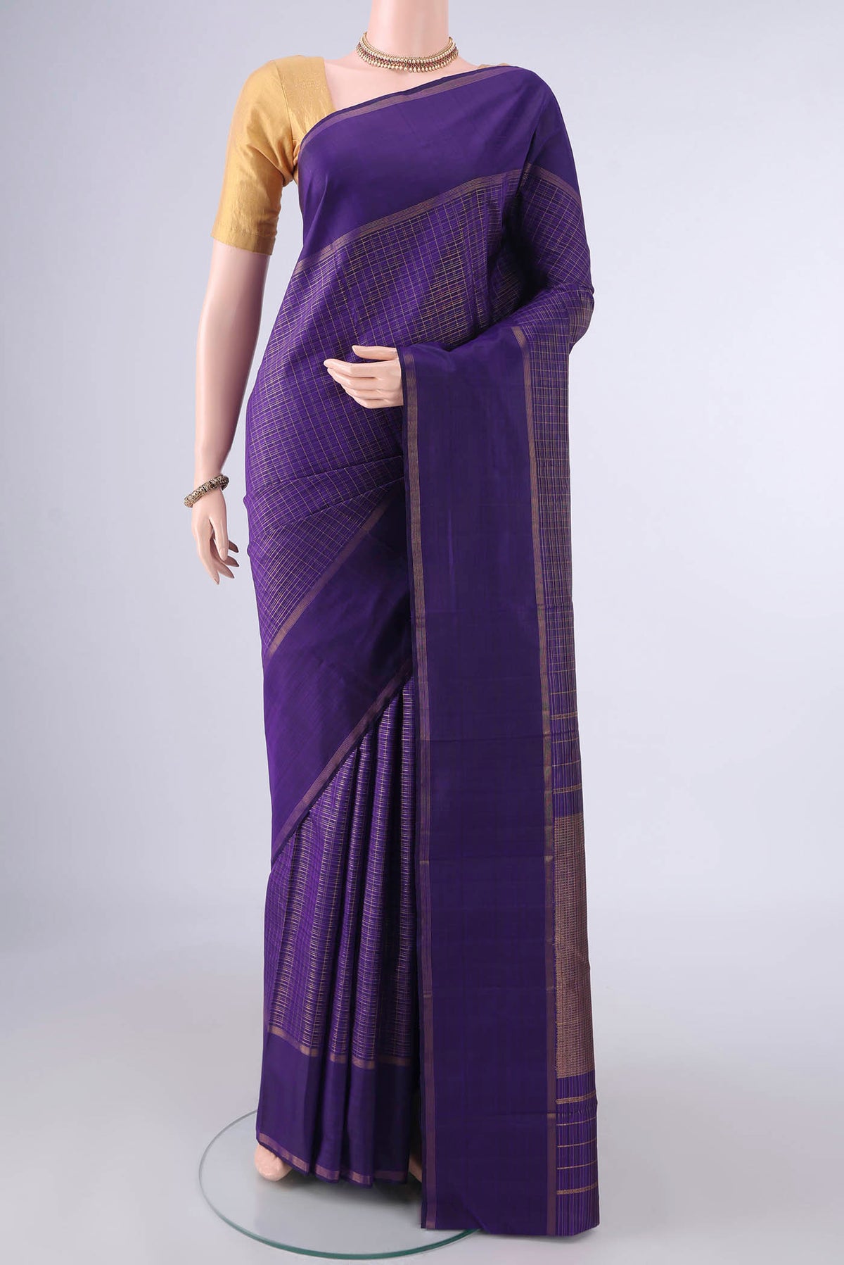 Pure Silk Purple Kanchipuram Saree with Checked design on the body and Plain Border.  displayed on a mannequin