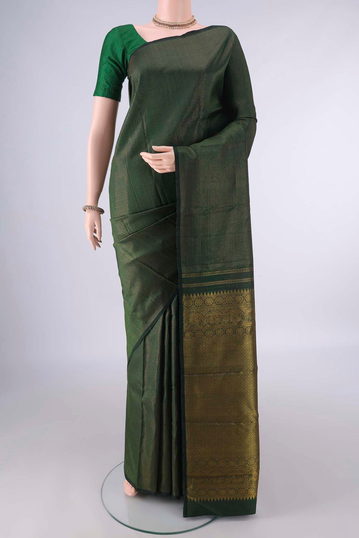 Pure Silk Bottle Green Kanjivaram Saree with Checked design on the body and Without Border.  displayed on a mannequin