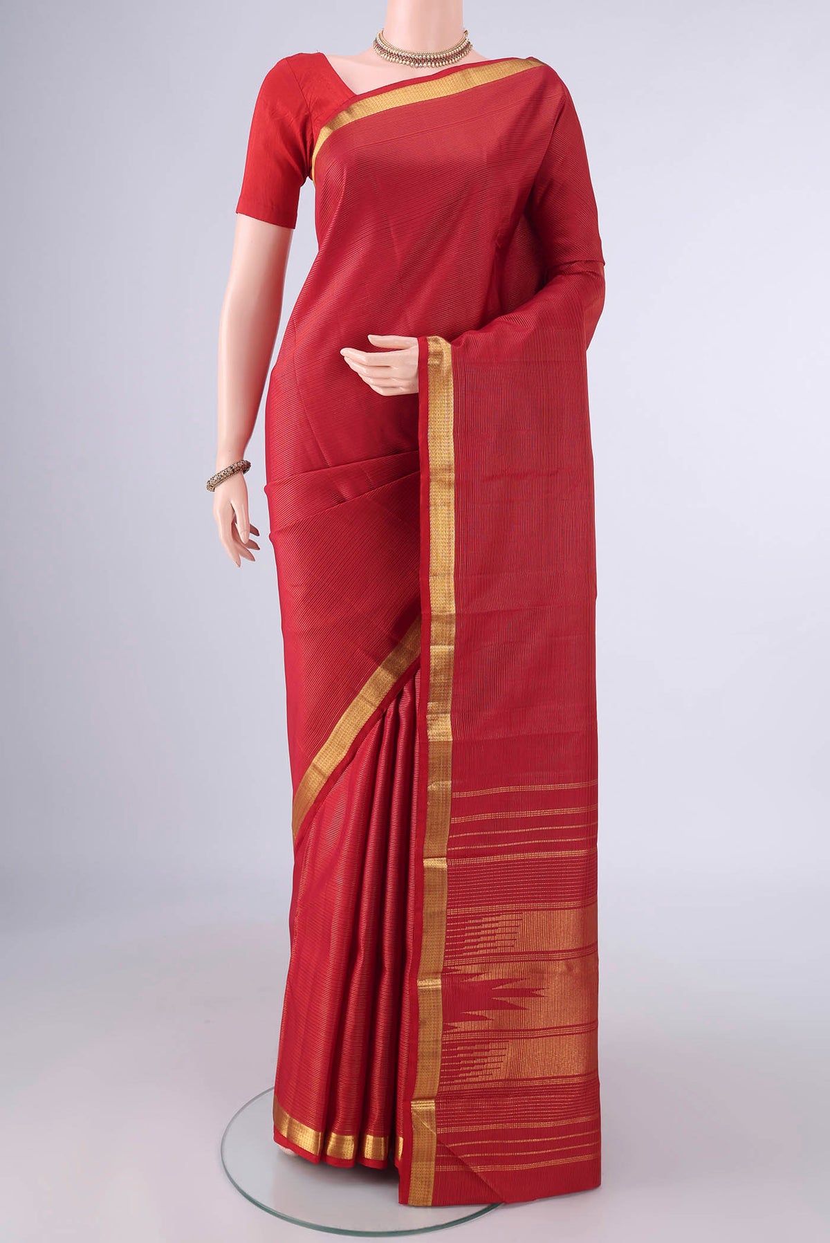 Pure Silk Red Kanjivaram Saree with Stripes on the body and Zari Border.  displayed on a mannequin