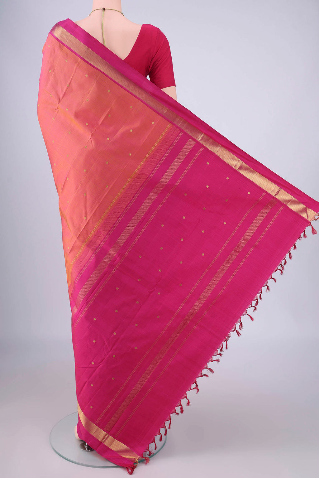 Flat view of Pinkish Yellow Dual Tone Kanjivaram Silk Saree with Zari Butta on the body and Zari Border. 