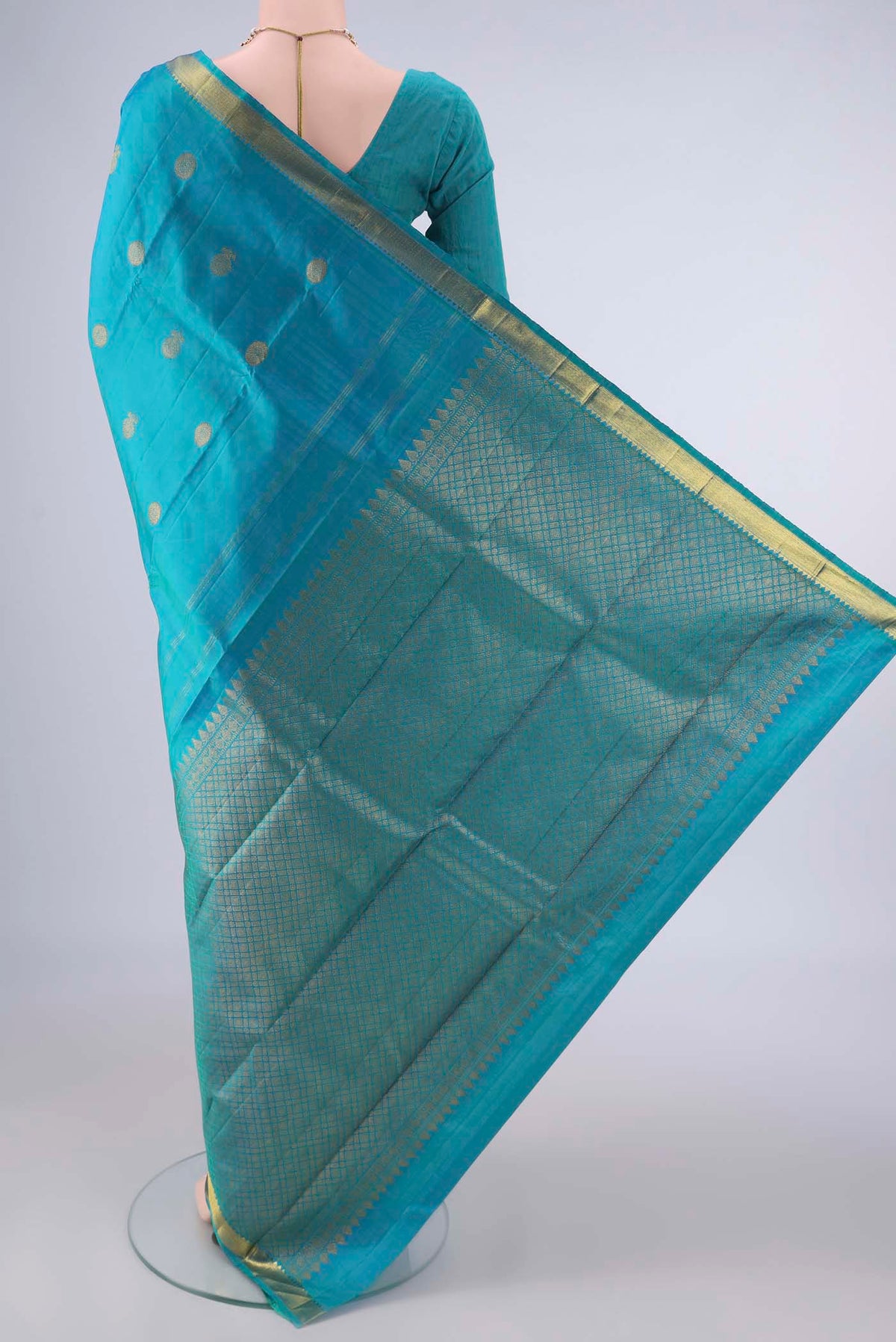 Flat view of Pure Silk Turquoise Kanchipuram Saree with Zari Butta on the body and Zari Border. 