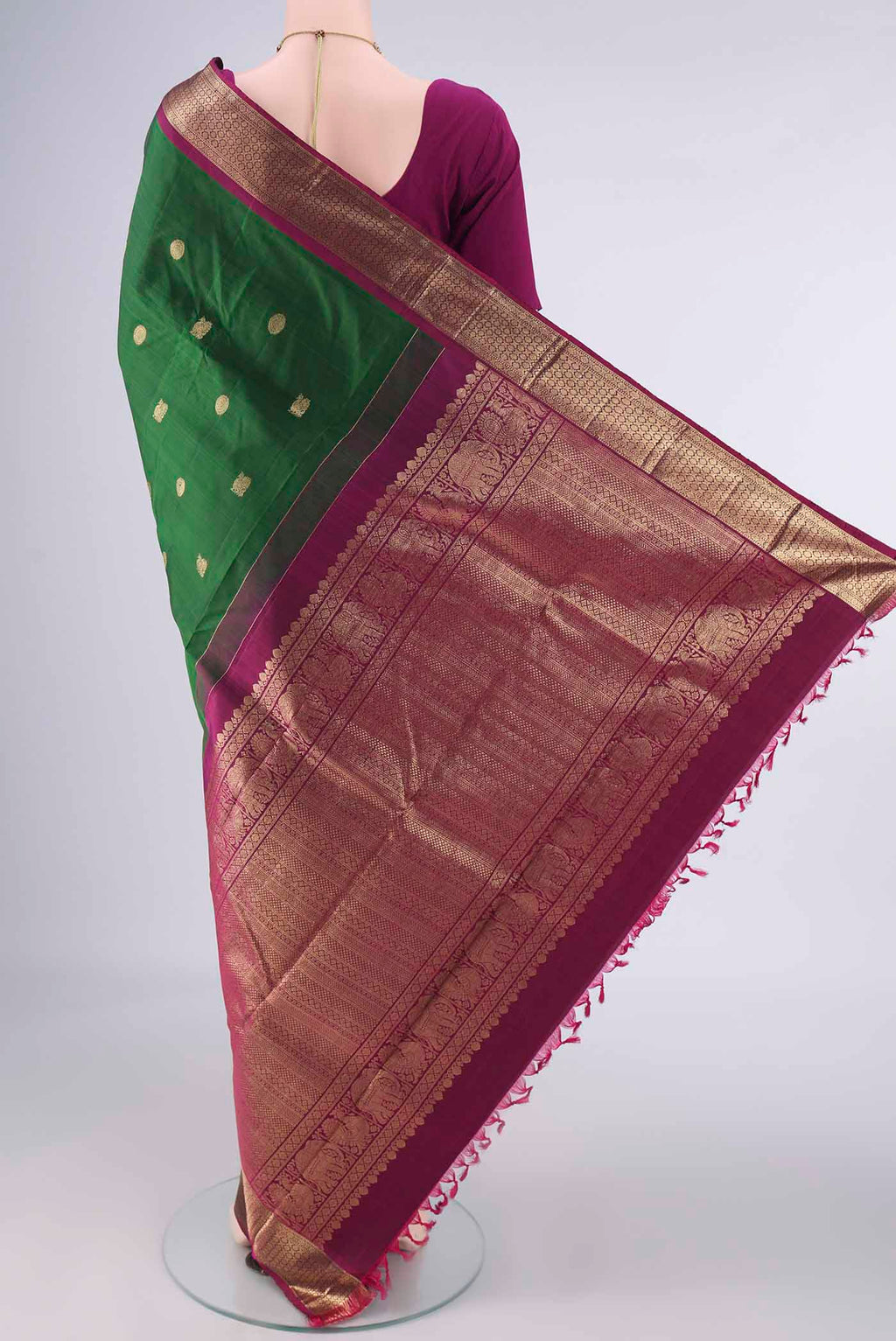 Flat view of Pure Silk Bottle Green Kanchipuram Saree with Zari Butta on the body and Zari Border. 