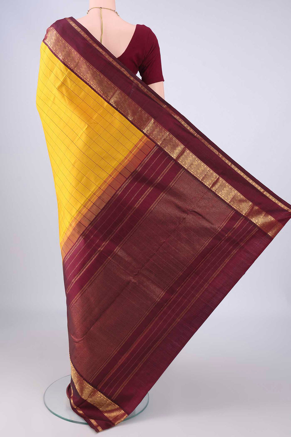 Flat view of Yellow Kanjivaram Silk Saree with Checked design on the body and Zari Border. 