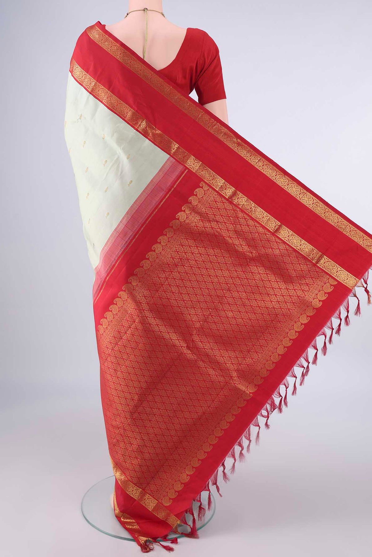 Flat view of Pure Silk Light Green Kanjivaram Saree with Zari Butta on the body and Zari Border. 