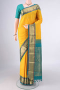 Pure Silk Yellow Kanchipuram Saree with Zari Butta on the body and Zari Border.  displayed on a mannequin