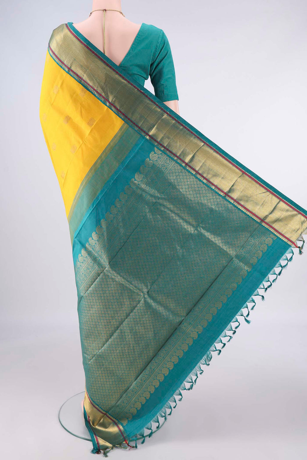 Flat view of Pure Silk Yellow Kanchipuram Saree with Zari Butta on the body and Zari Border. 