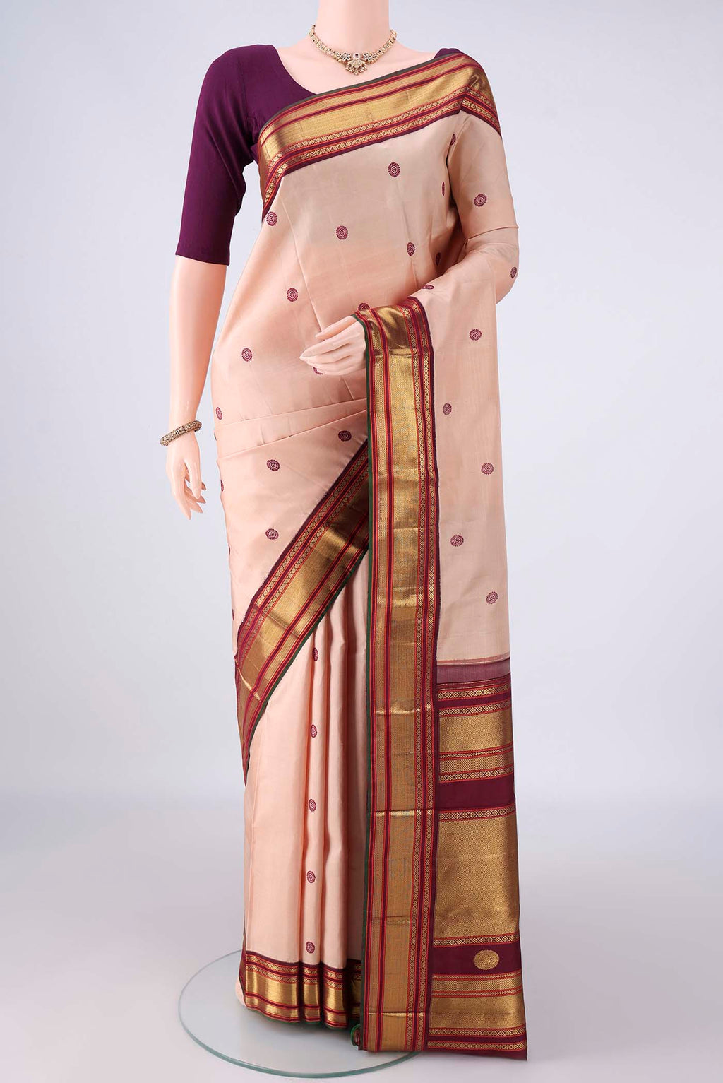 Pure Silk Sandal Kanjivaram Saree with Thread Butta on the body and Zari Border.  displayed on a mannequin