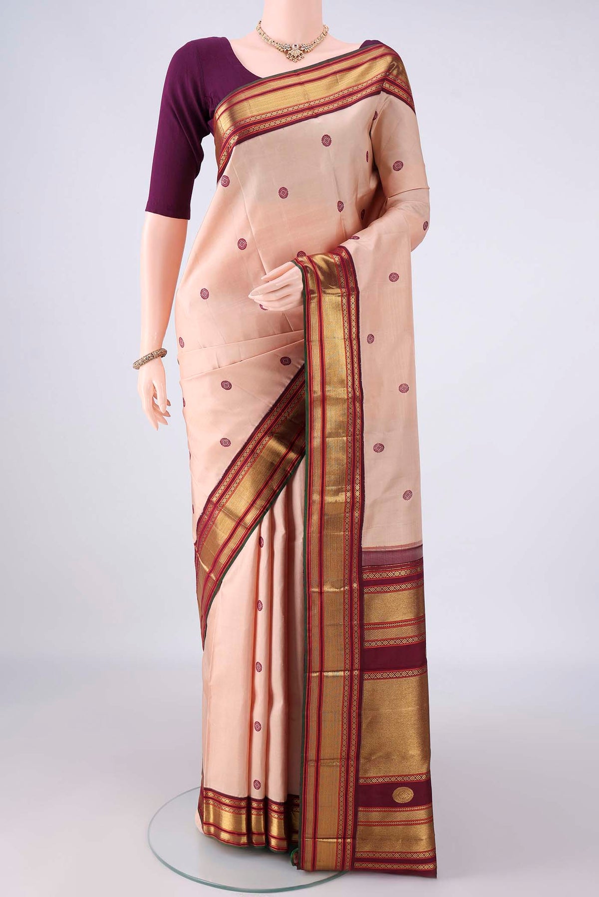 Pure Silk Sandal Kanjivaram Saree with Thread Butta on the body and Zari Border.  displayed on a mannequin