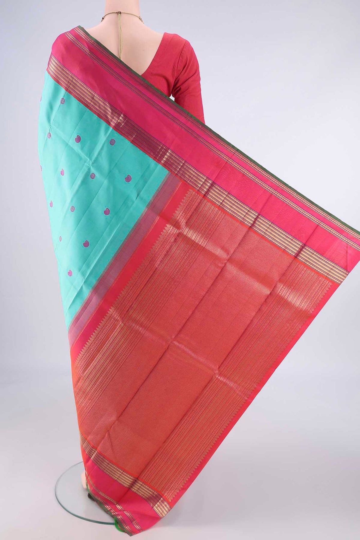 Flat view of Pure Silk Pure Zari Turquoise Kanchipuram Saree with Thread Butta on the body and Zari Border. 