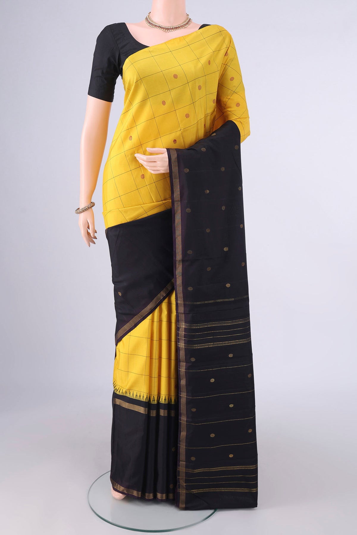 Pure Silk Yellow Kanjivaram Saree with Checked design on the body and One Side Border.  displayed on a mannequin