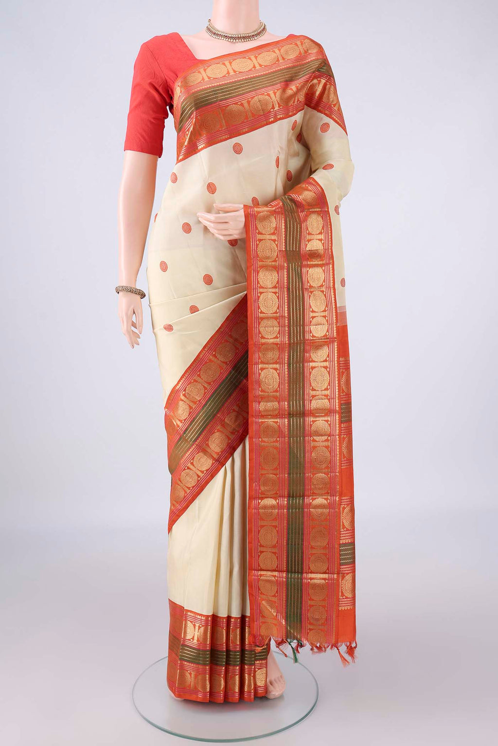 Pure Silk Cream Kanjivaram Saree with Thread Butta on the body and Zari Border.  displayed on a mannequin