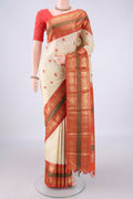 Pure Silk Cream Kanjivaram Saree with Thread Butta on the body and Zari Border.  displayed on a mannequin