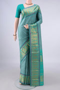 Pure Silk Sage Green Kanchipuram Saree with Thread Butta on the body and Zari And Thread Border.  displayed on a mannequin