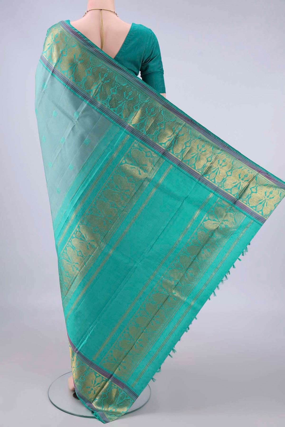 Flat view of Pure Silk Sage Green Kanchipuram Saree with Thread Butta on the body and Zari And Thread Border. 