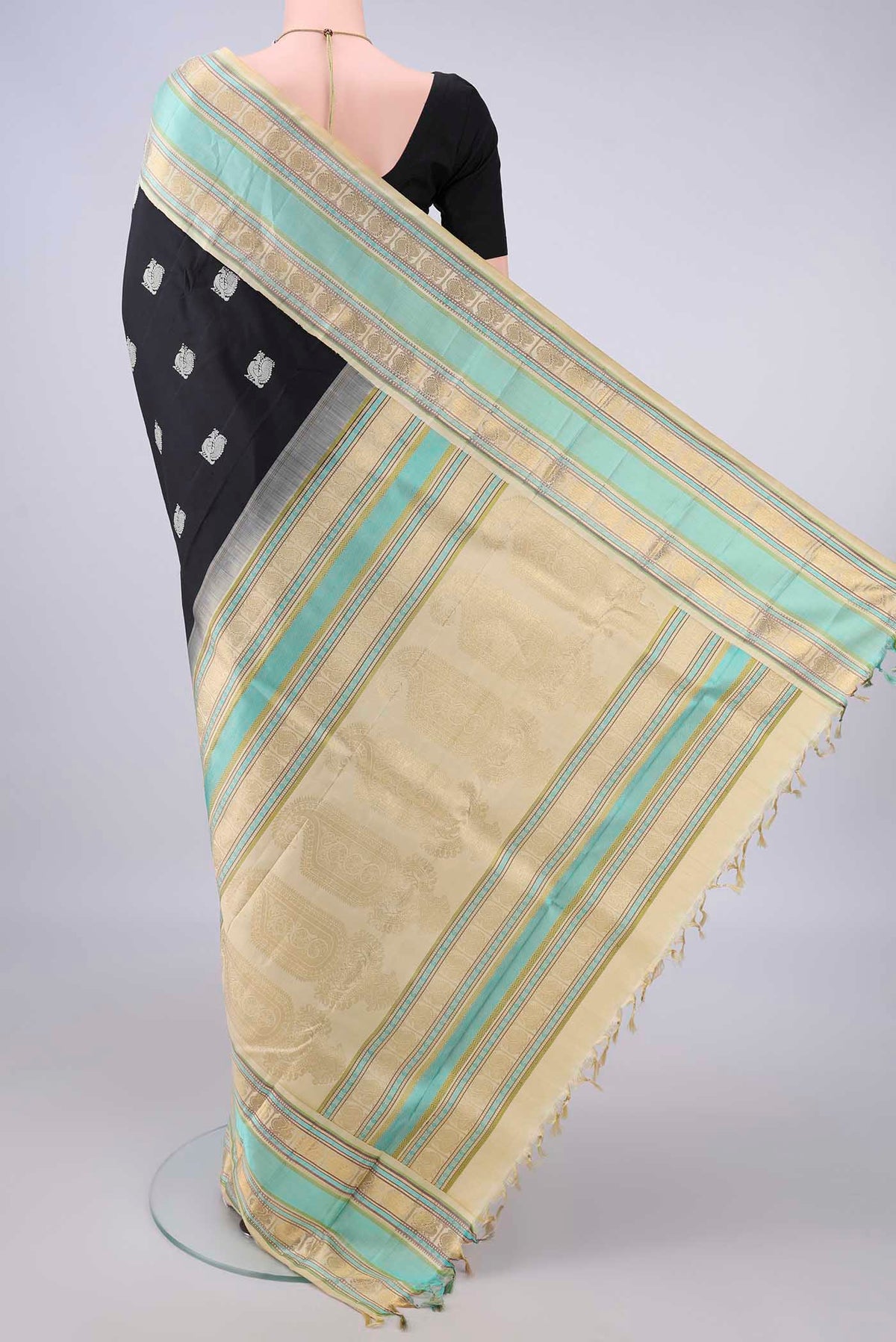 Flat view of Pure Silk Black Kanchipuram Saree with Thread Butta on the body and Zari And Thread Border. 