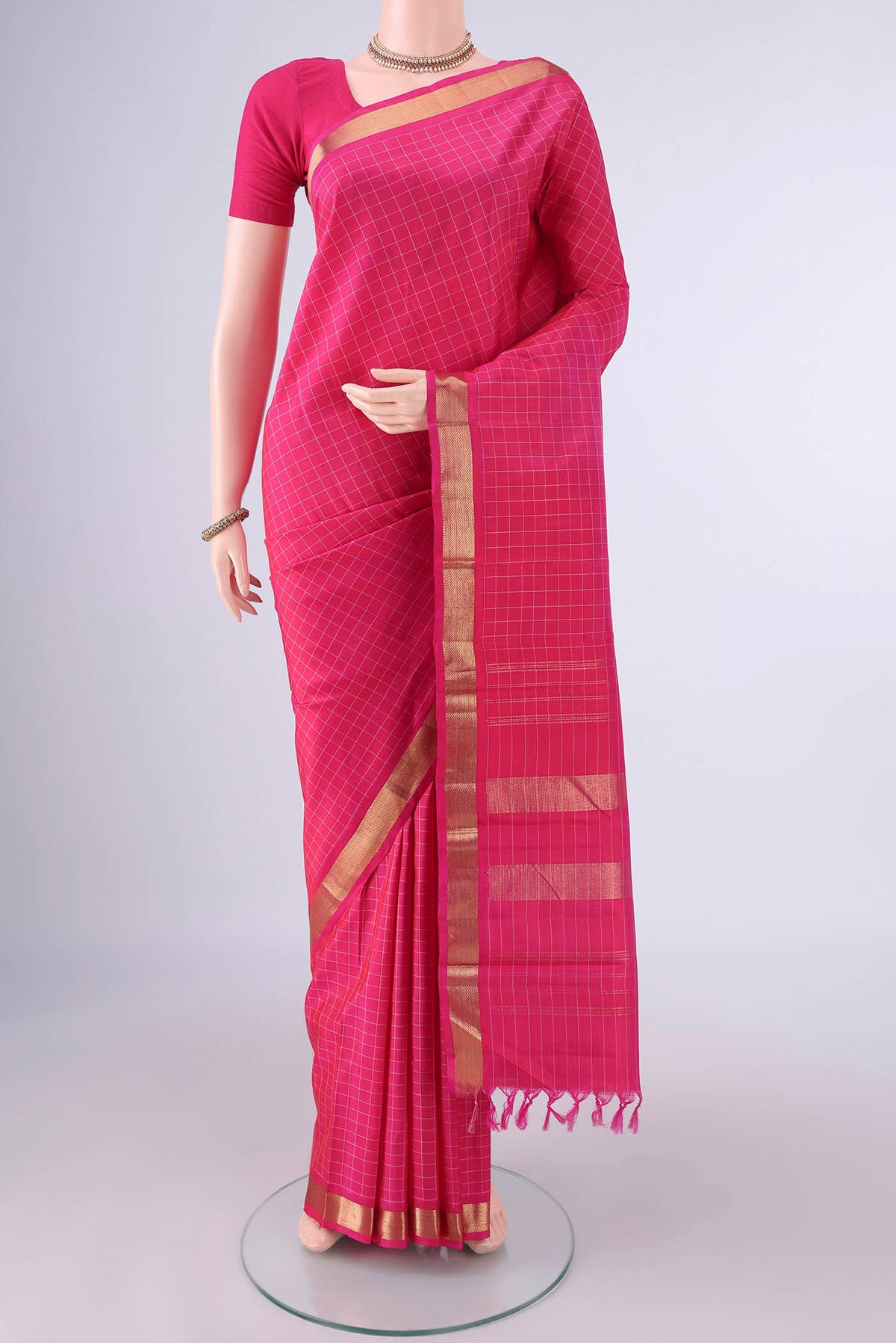 Pure Silk Pink Kanjivaram Saree with Checked design on the body and Zari Border.  displayed on a mannequin