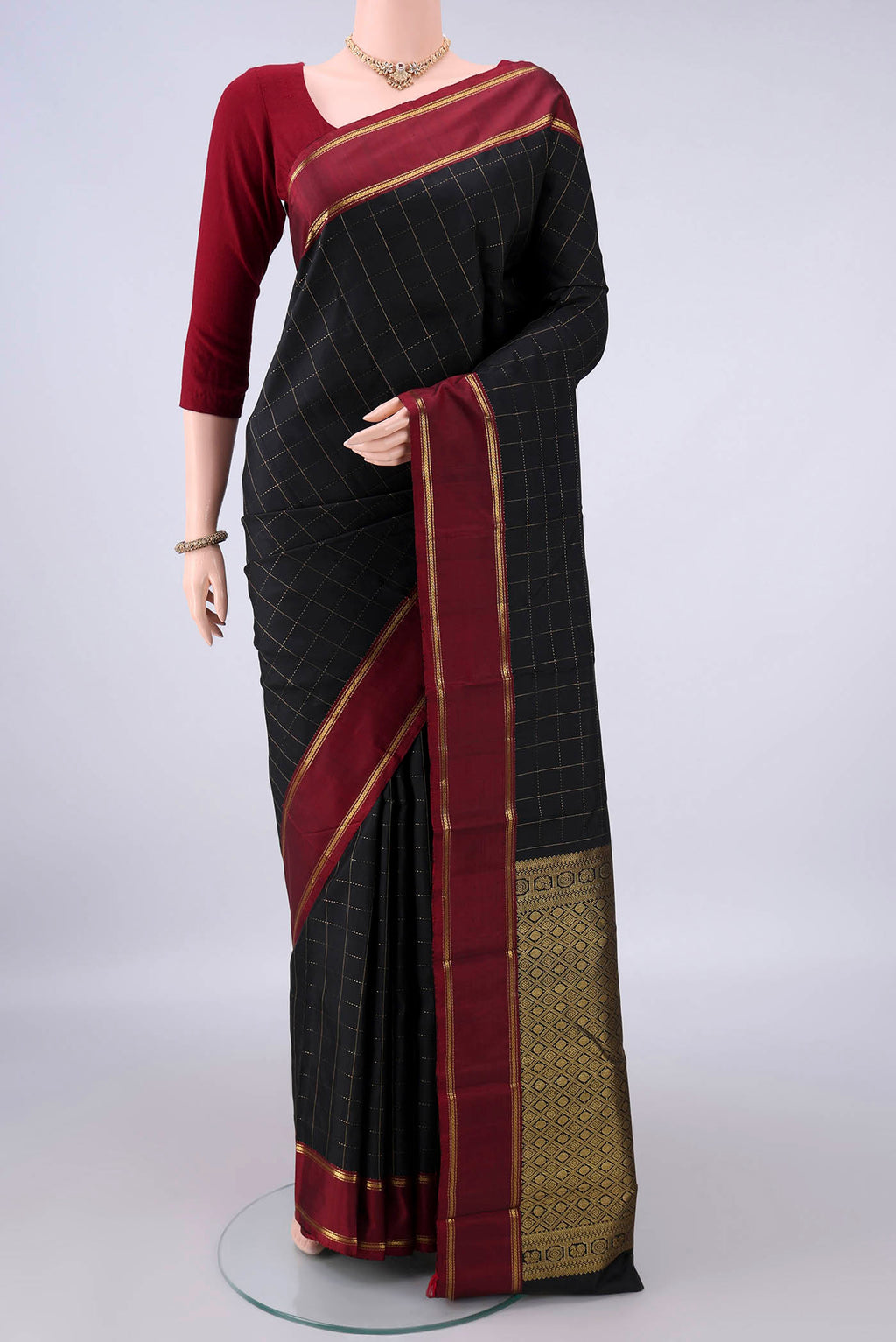Pure Silk Black Kanchipuram Saree with Checked design on the body and Plain Border.  displayed on a mannequin