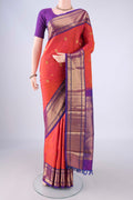 Orange Kanchipuram Silk Saree with Zari Butta on the body and Zari Border.  displayed on a mannequin