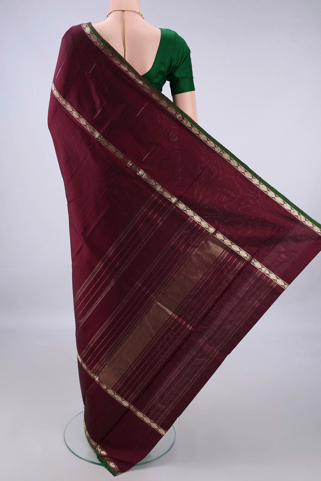 Flat view of Pure Silk Maroon Kanchipuram Saree with Plain Body and Zari Border. 