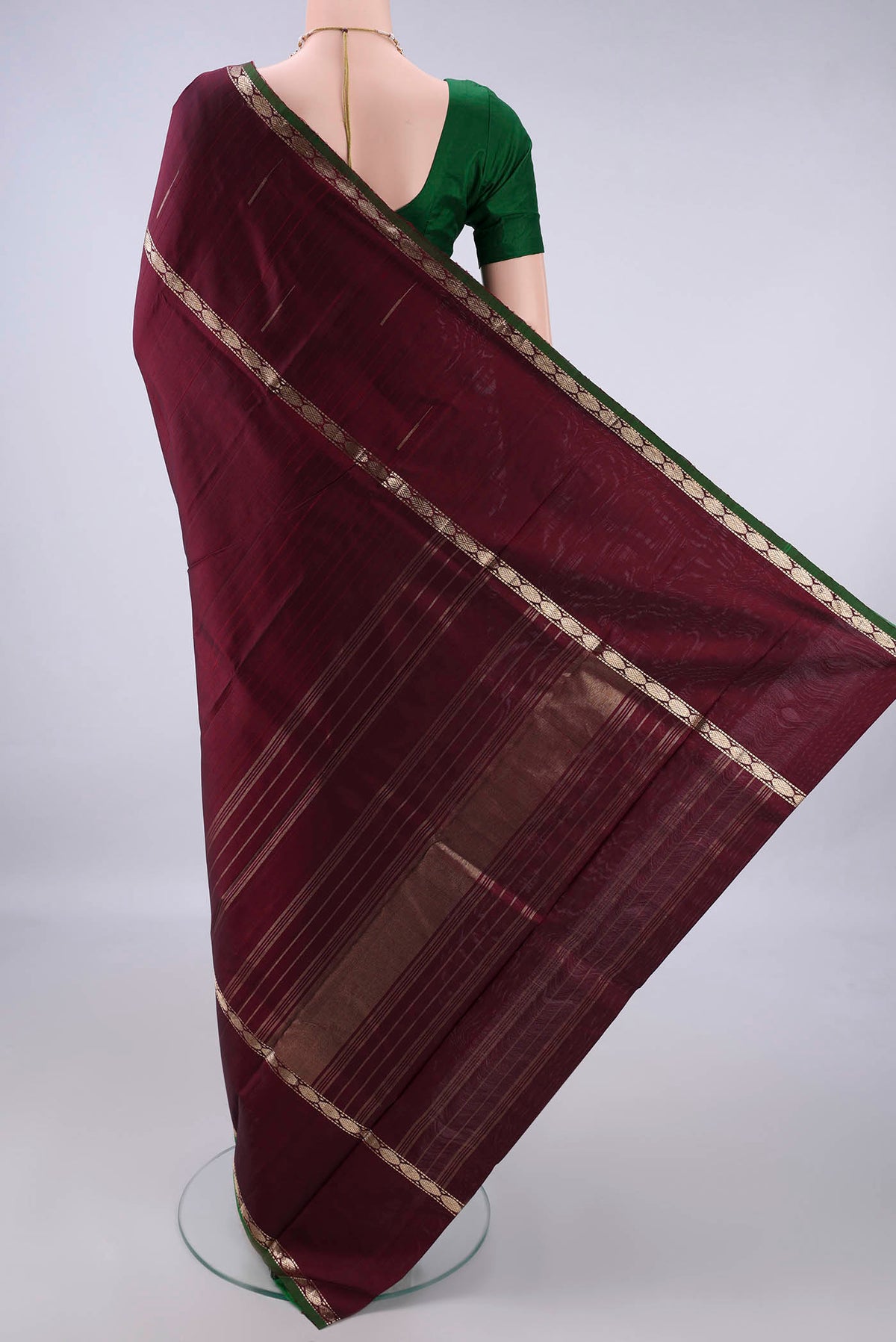 Flat view of Pure Silk Maroon Kanchipuram Saree with Plain Body and Zari Border. 