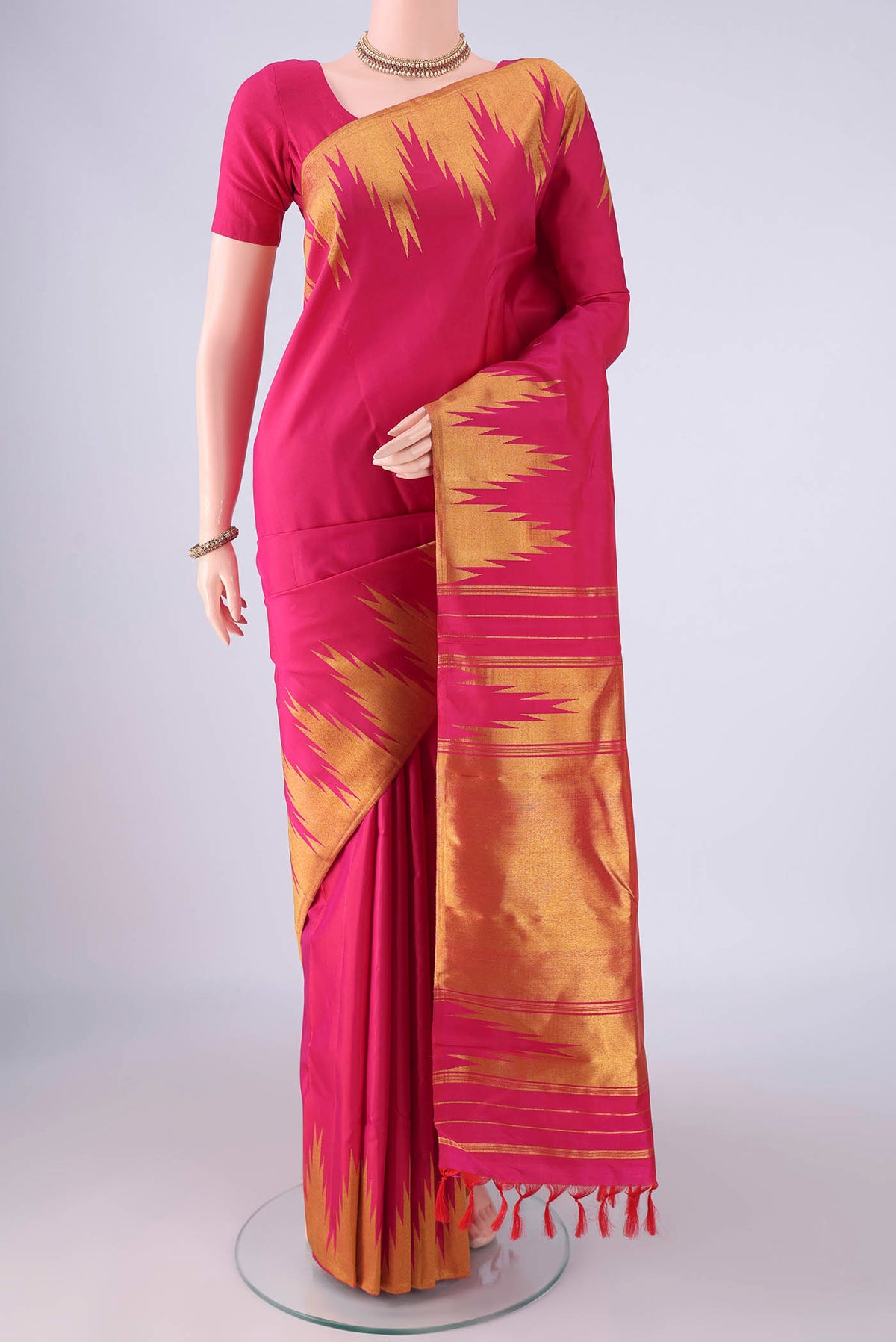 Rani Pink Kanjivaram Silk Saree with Plain Body and Temple Border.  displayed on a mannequin