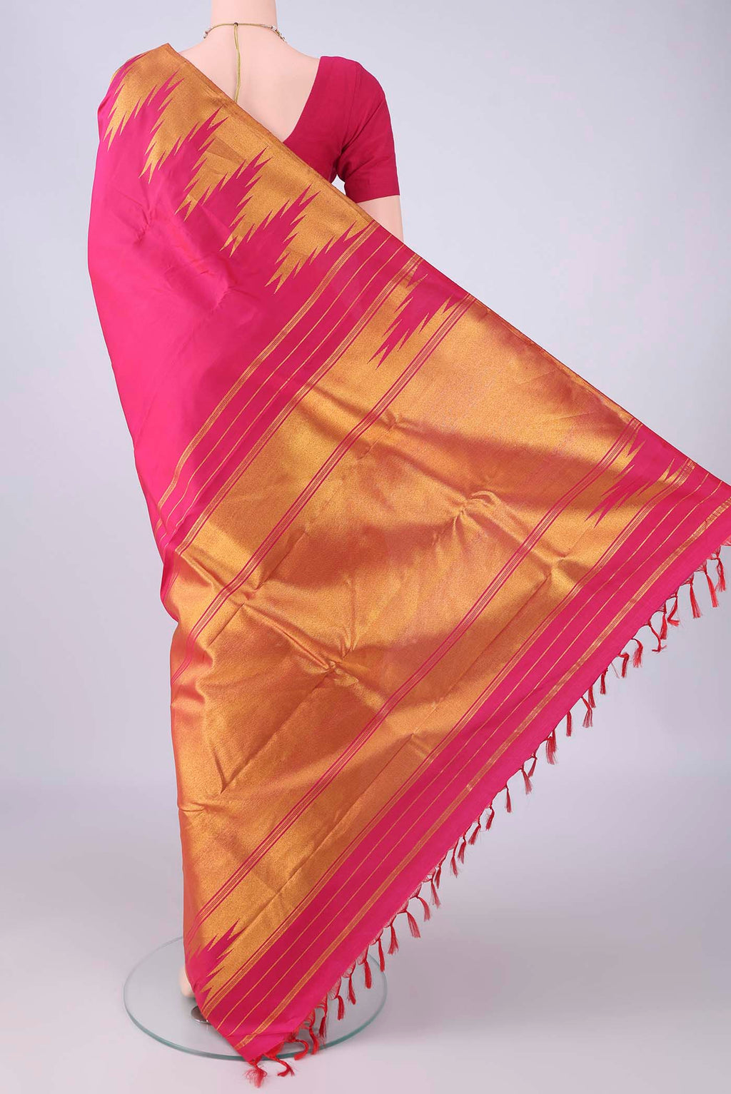 Flat view of Rani Pink Kanjivaram Silk Saree with Plain Body and Temple Border. 