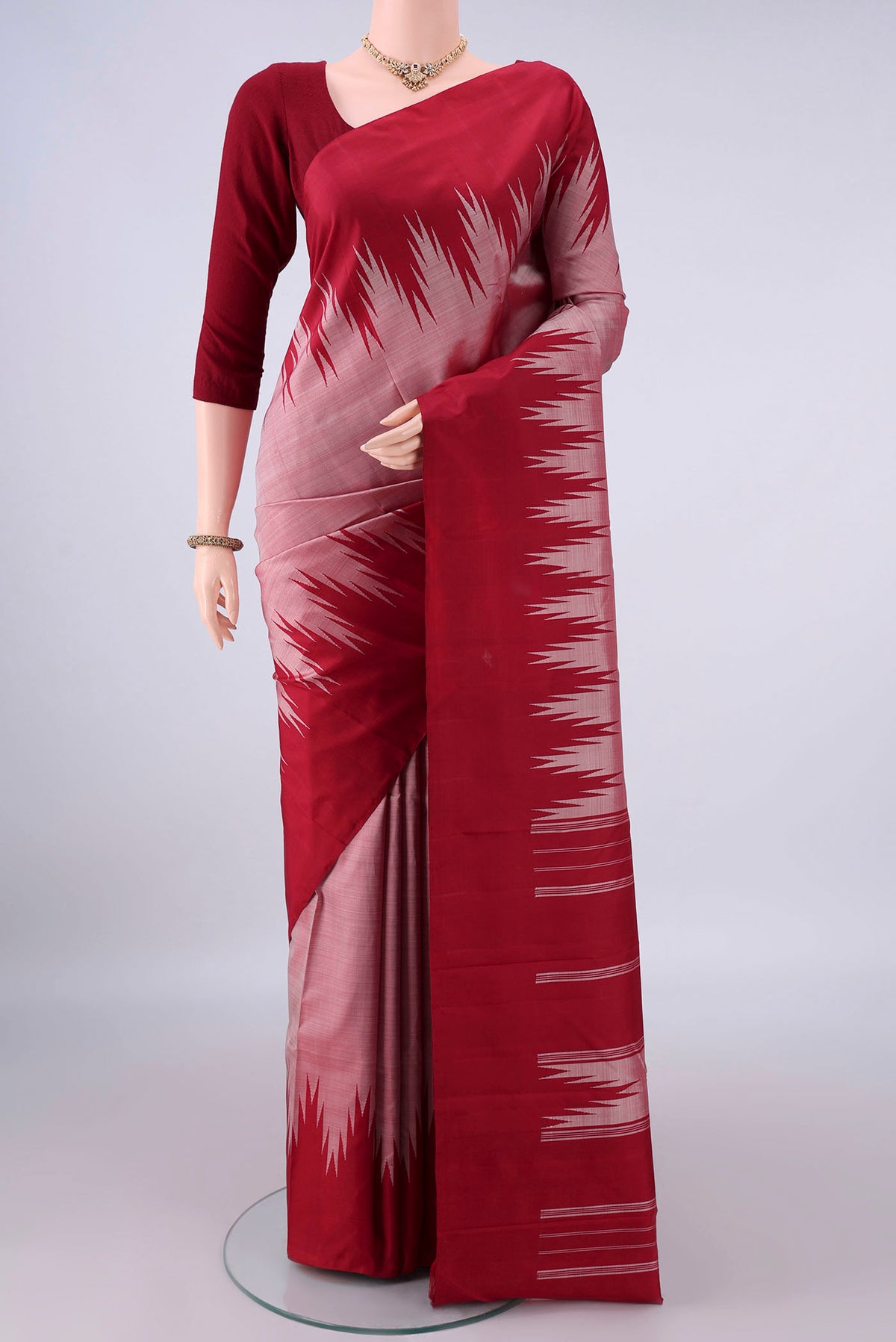 Pure Silk Peach Kanchipuram Saree with Plain Body and Temple Border.  displayed on a mannequin