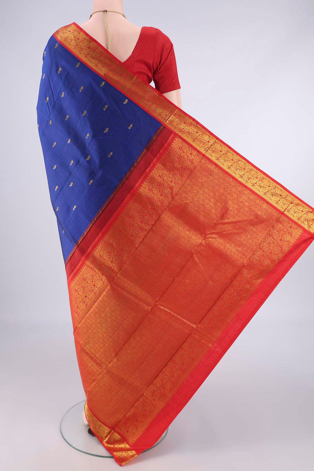 Flat view of Pure Silk Royal Blue Kanjivaram Saree with Zari Butta on the body and Zari Border. 