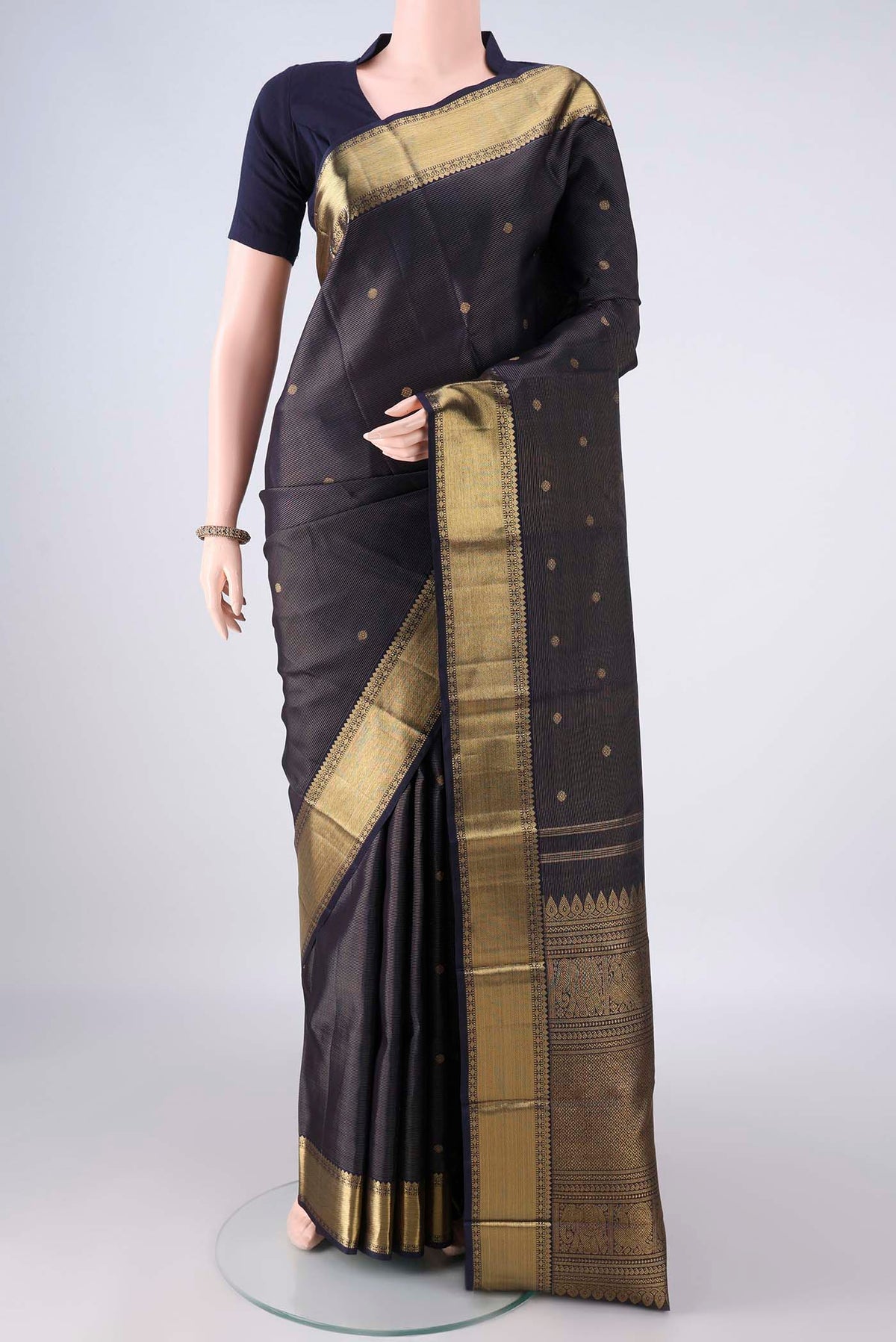 Pure Silk Pure Zari Navy Blue Kanjivaram Saree with Zari Butta on the body and Zari Border.  displayed on a mannequin