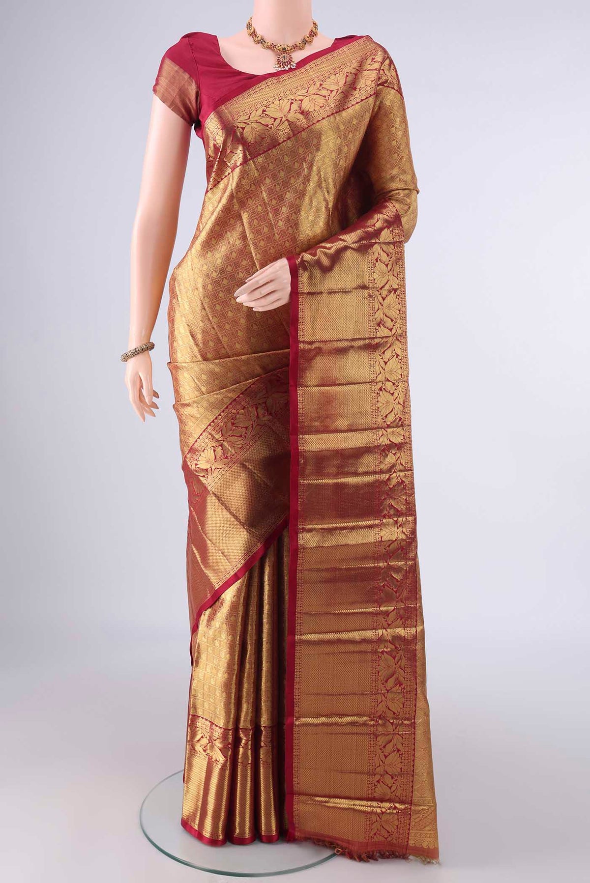 Pure Silk Pure Zari Golden Dual Tone Kanjivaram Tissue Saree with Zari Brocade on the body and Zari Border.  displayed on a mannequin