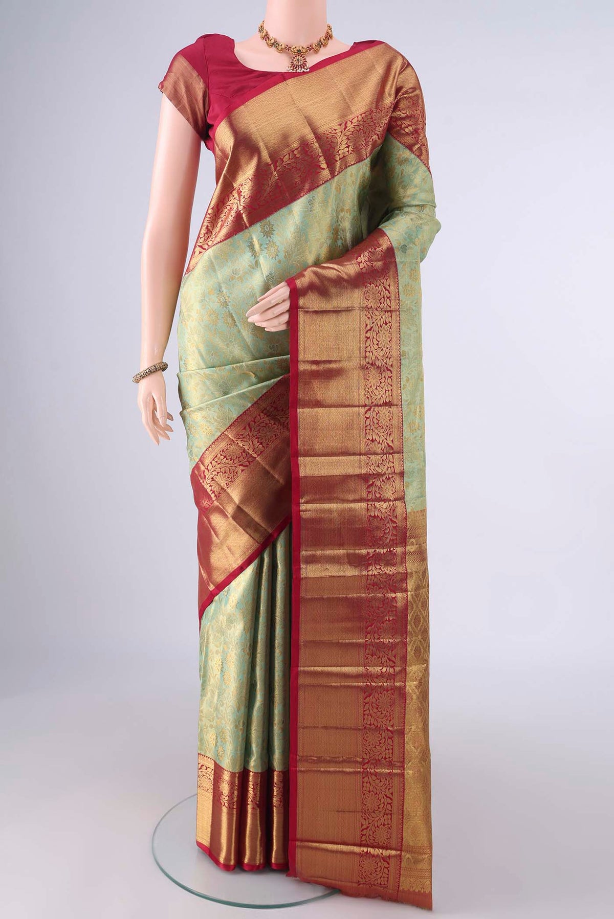 Pure Silk Pure Zari Pista Green Dual Tone Kanjivaram Tissue Saree with Zari Brocade on the body and Zari Border.  displayed on a mannequin