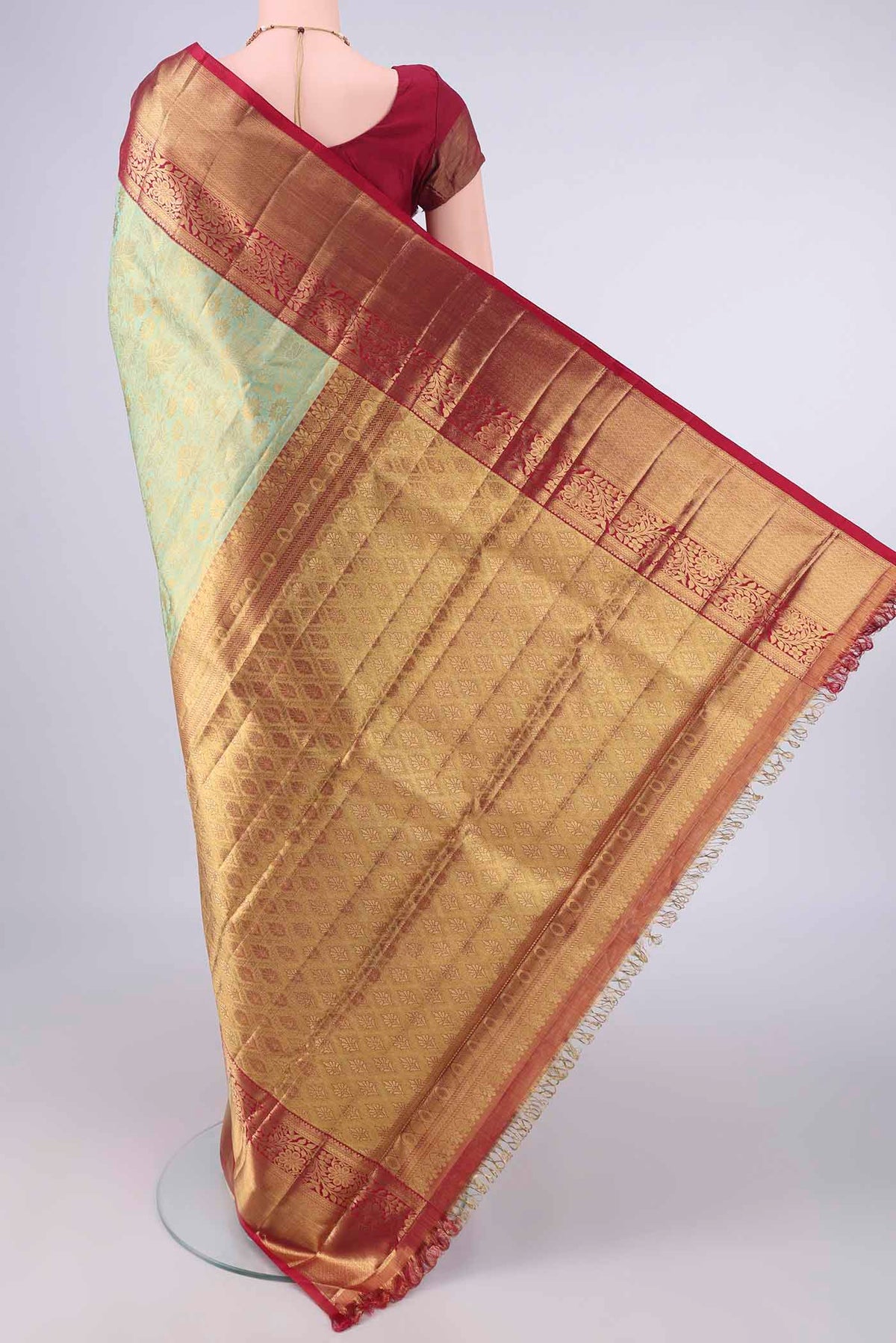 Flat view of Pure Silk Pure Zari Pista Green Dual Tone Kanjivaram Tissue Saree with Zari Brocade on the body and Zari Border. 