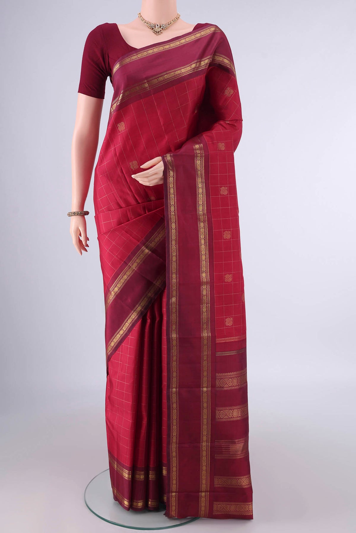 Pure Silk Pure Zari Maroon Kanchipuram Saree with Checked design on the body and Thin Zari Line.  displayed on a mannequin