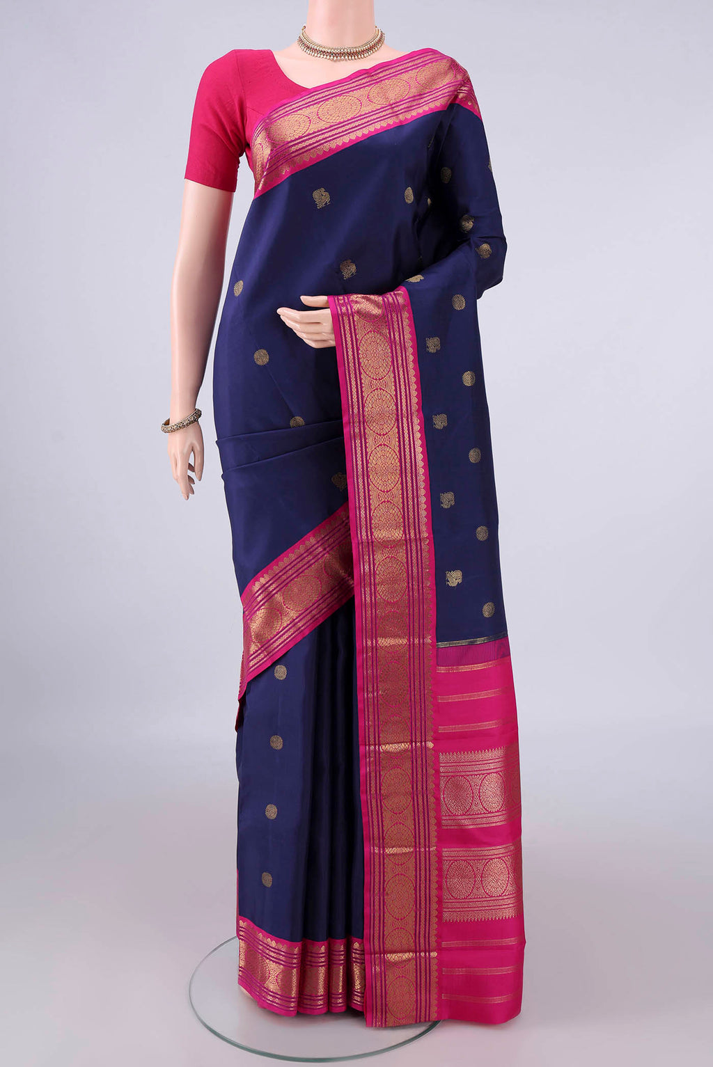 Pure Silk Pure Zari Navy Blue Kanjivaram Saree with Zari Butta on the body and Zari Border.  displayed on a mannequin