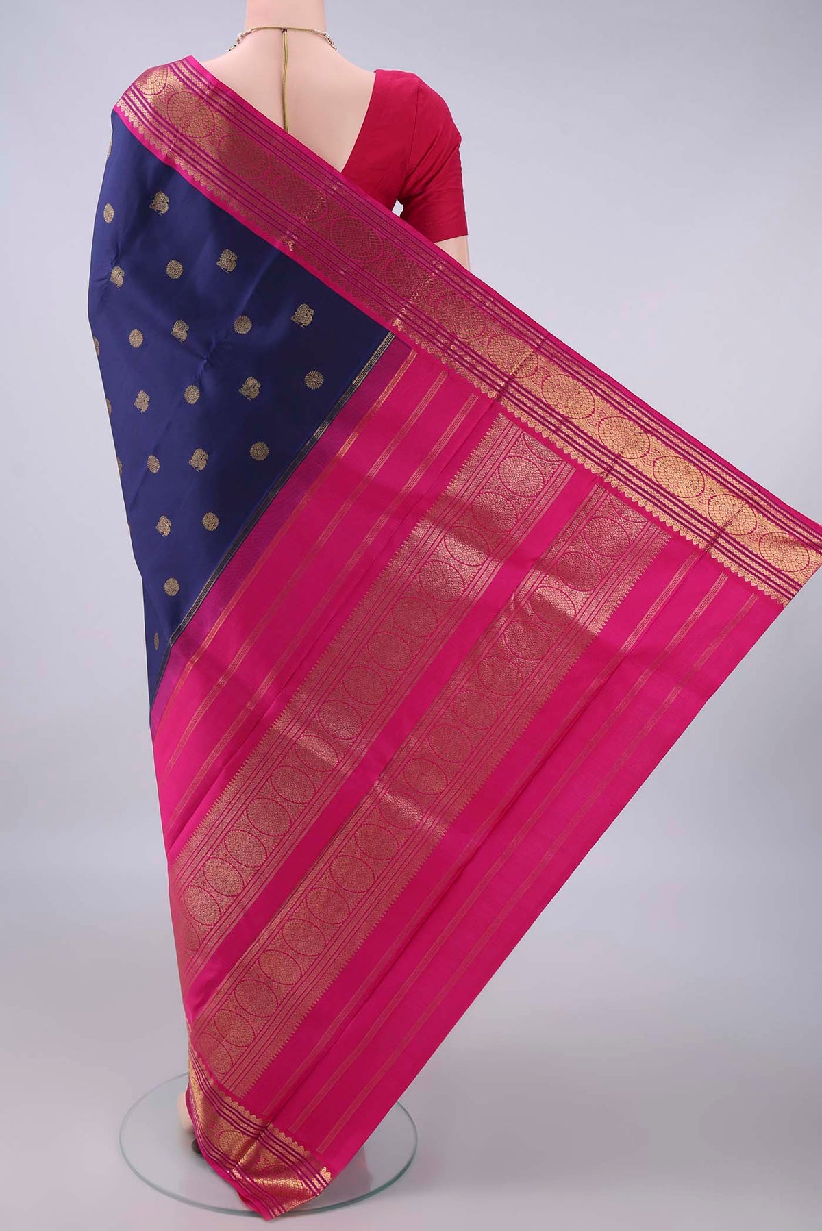 Flat view of Pure Silk Pure Zari Navy Blue Kanjivaram Saree with Zari Butta on the body and Zari Border. 