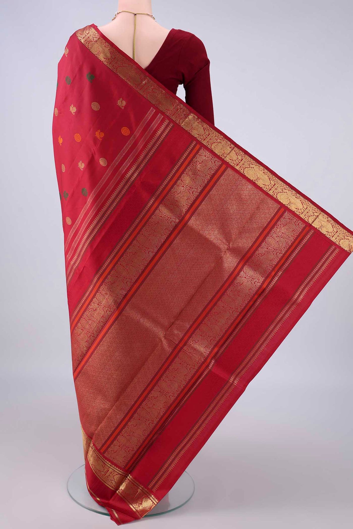 Flat view of Pure Silk Pure Zari Maroon Kanjivaram Saree with Zari And Thread Butta on the body and Zari And Thread Border. 